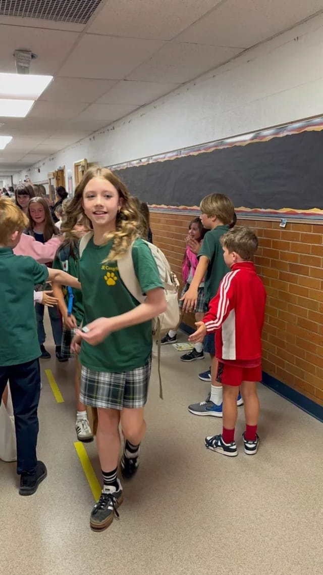 J.E. Cosgriff Memorial Catholic School students gathered in a brightly lit hallway.