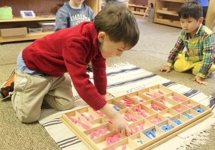 The Family Academy of Bethesda in Bethesda: child working with classroom materials.
