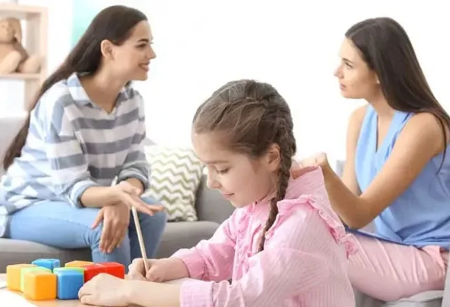 Parent and professional talking together at a table