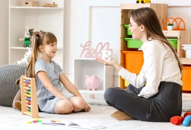 Adult supporting a child during a communication activity