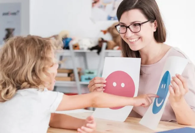 Adult and child using picture cards during an activity