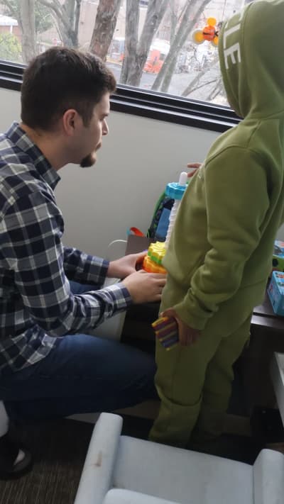 Therapist and child participating in an indoor activity at Autism Reimagined Center.