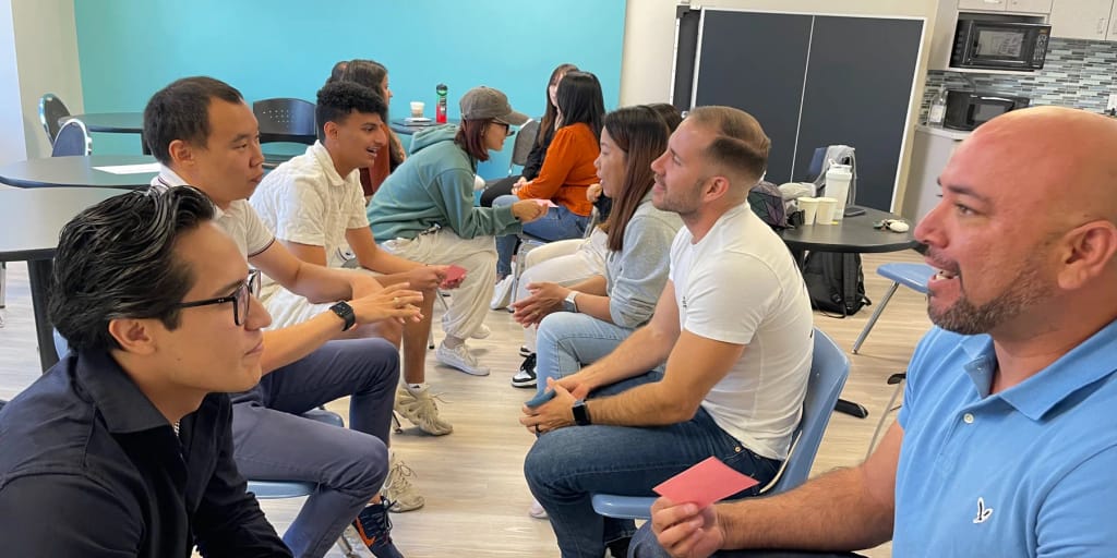 Students practicing conversation together in a classroom