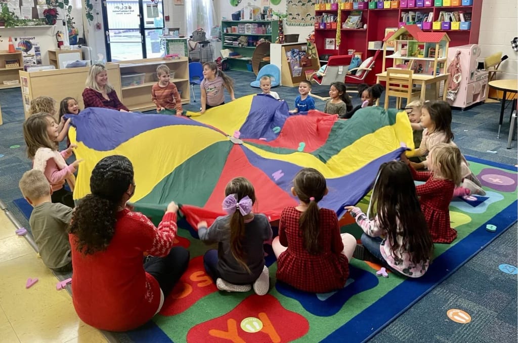 Early Learning Preschool children participating in a parachute activity.