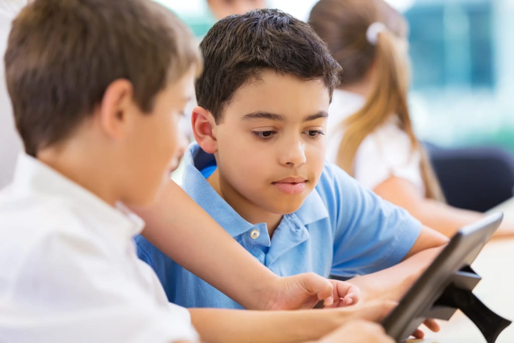 Children working together with a tablet during a learning activity