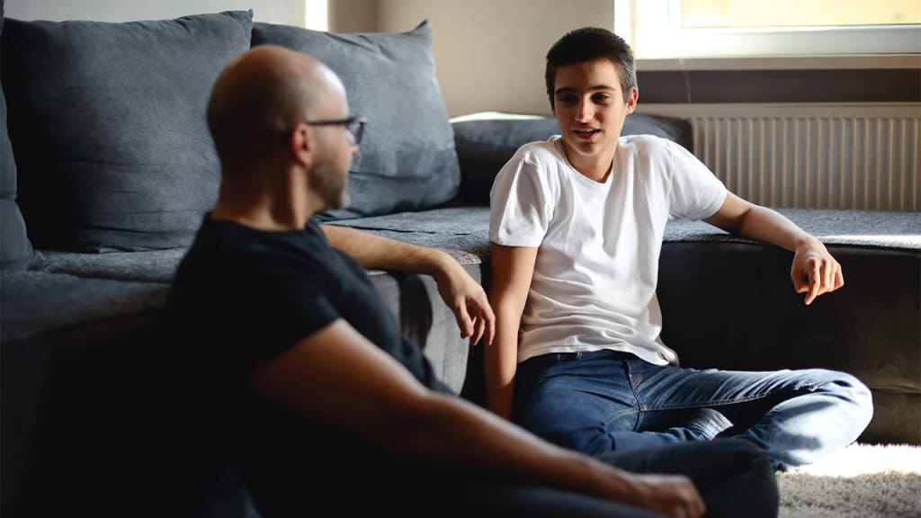 Adult and young person talking together at home