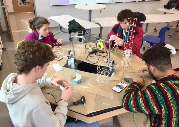 Students building a project together at a table during physics class at The Lab School of Washington in Washington, DC.