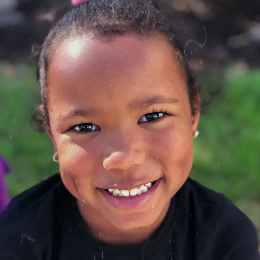 A Learning by Design Charter School student smiles outdoors