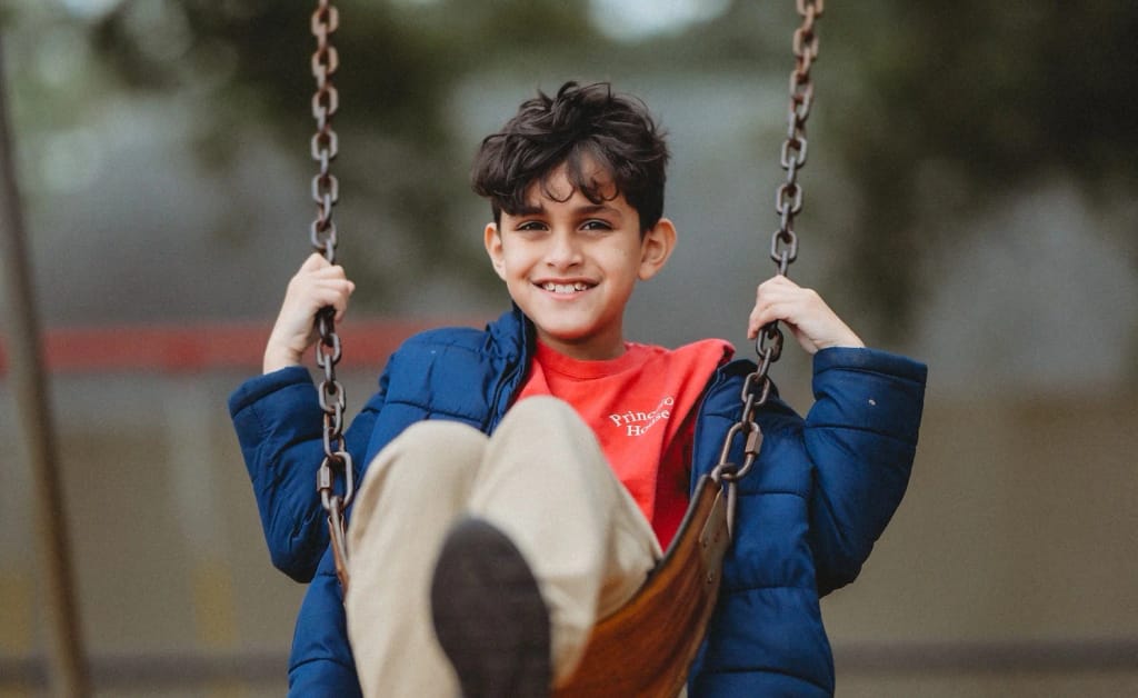 A Princeton House Charter School student enjoys an outdoor swing