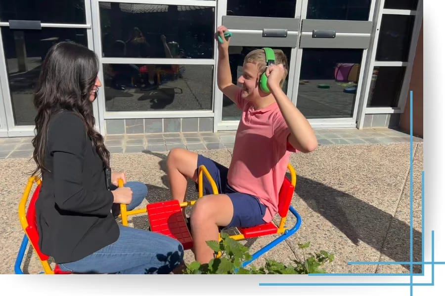 A Victory Autism Academy Phoenix student enjoys an outdoor bubble activity