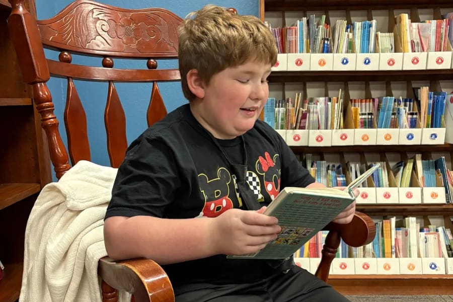 A Victory Autism Academy Phoenix student reads in a library
