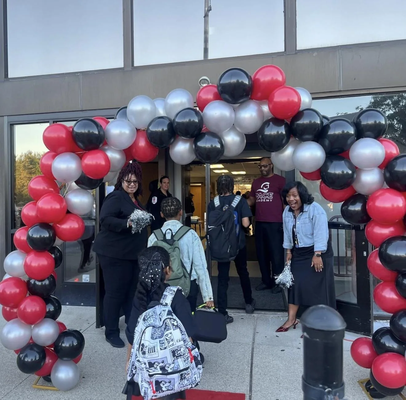 Pace Academy students and staff welcoming families at the school entrance