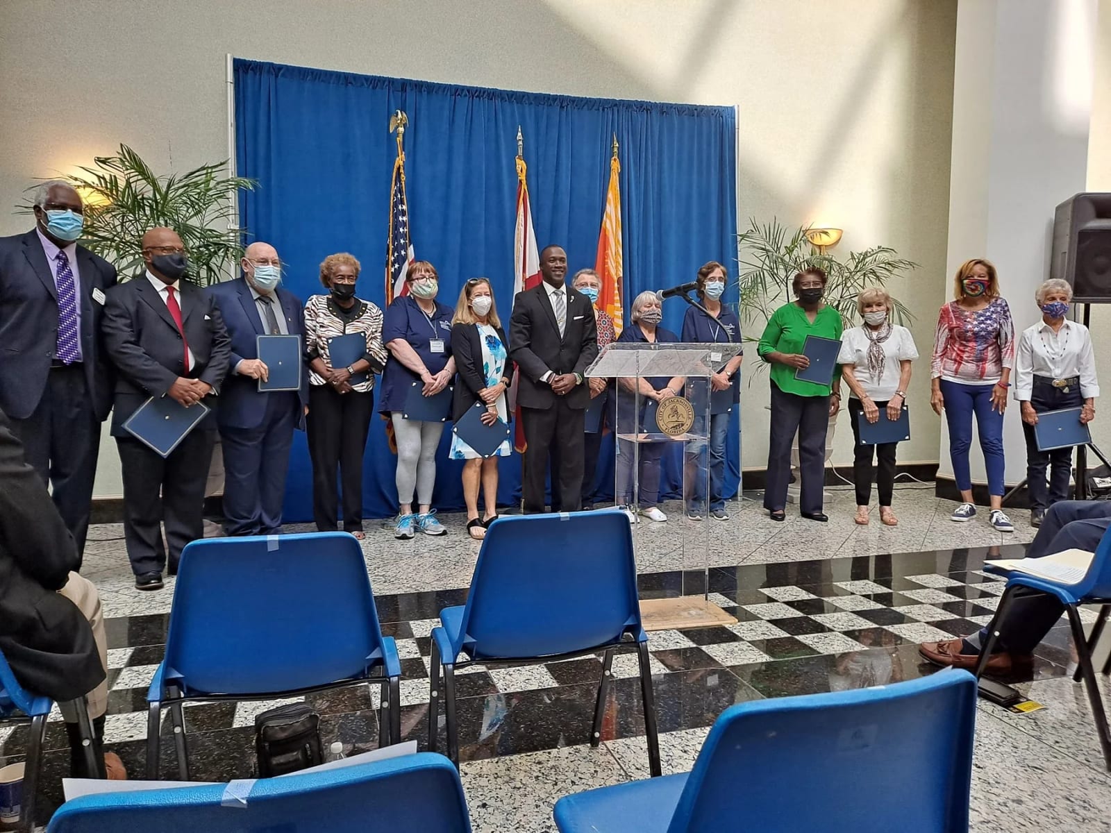 Center of Achievement staff and community members gather for a recognition event.