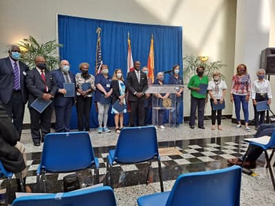 Center of Achievement staff and community members gather for a recognition event.