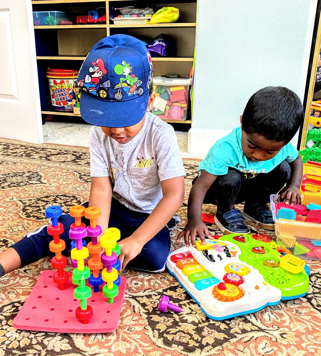 Gurukool children building with colorful classroom toys