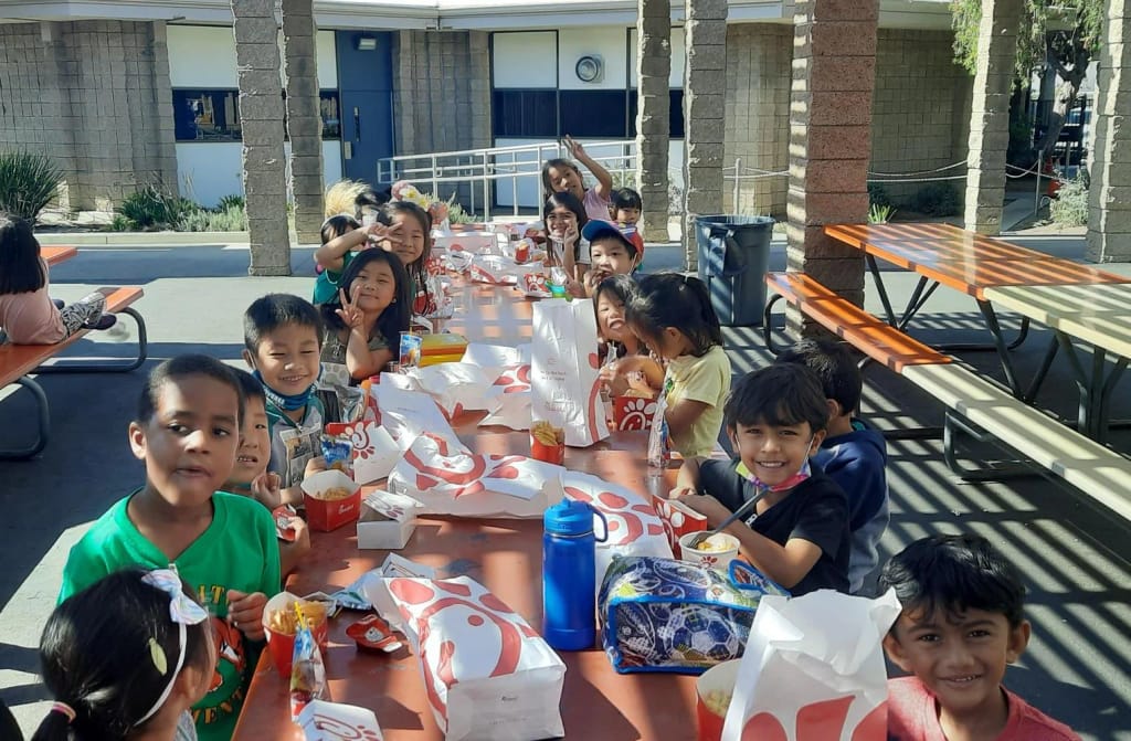 Cerritos Elementary School - Cerritos in Cerritos, CA: students sharing a school lunch outdoors.
