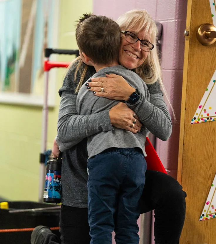 Southfield Christian School teacher greeting a young student