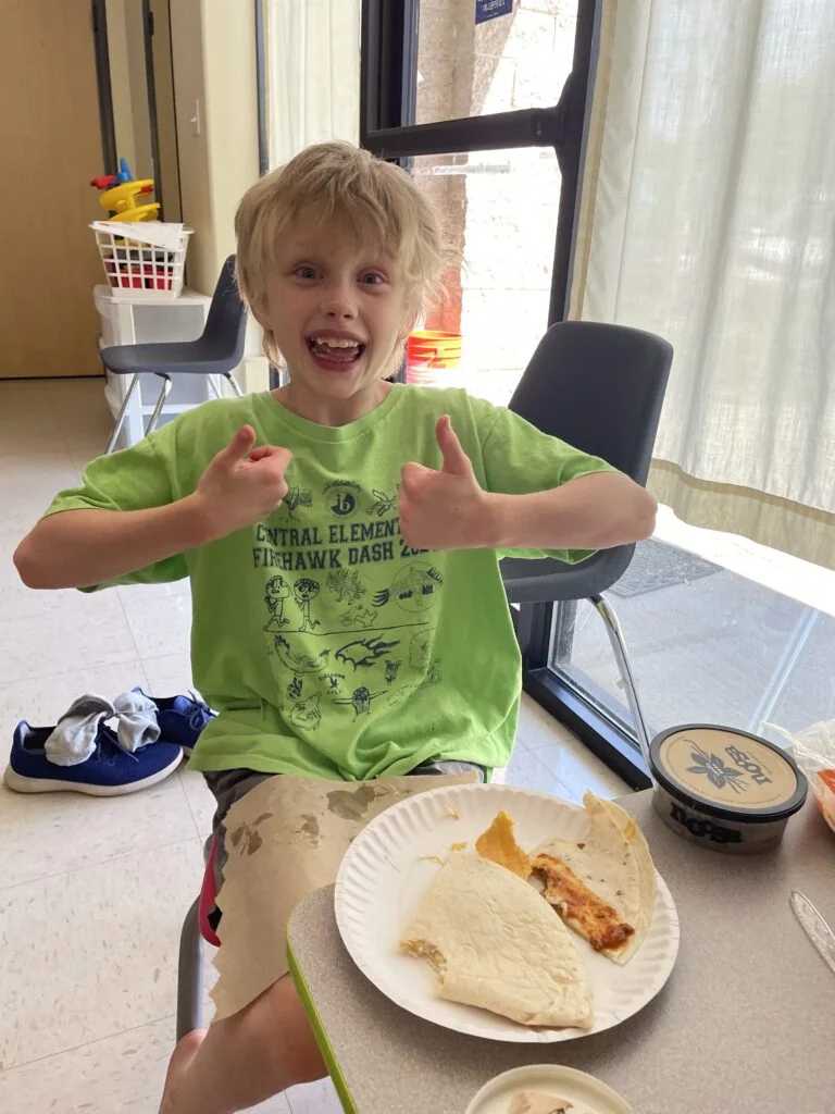 TLC Learning Center child participating in a meal activity