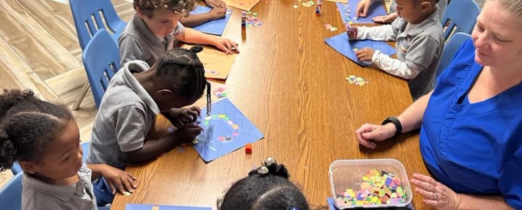 AA Academy Learning Center 3 in Hollywood: students working with a teacher at a classroom table.