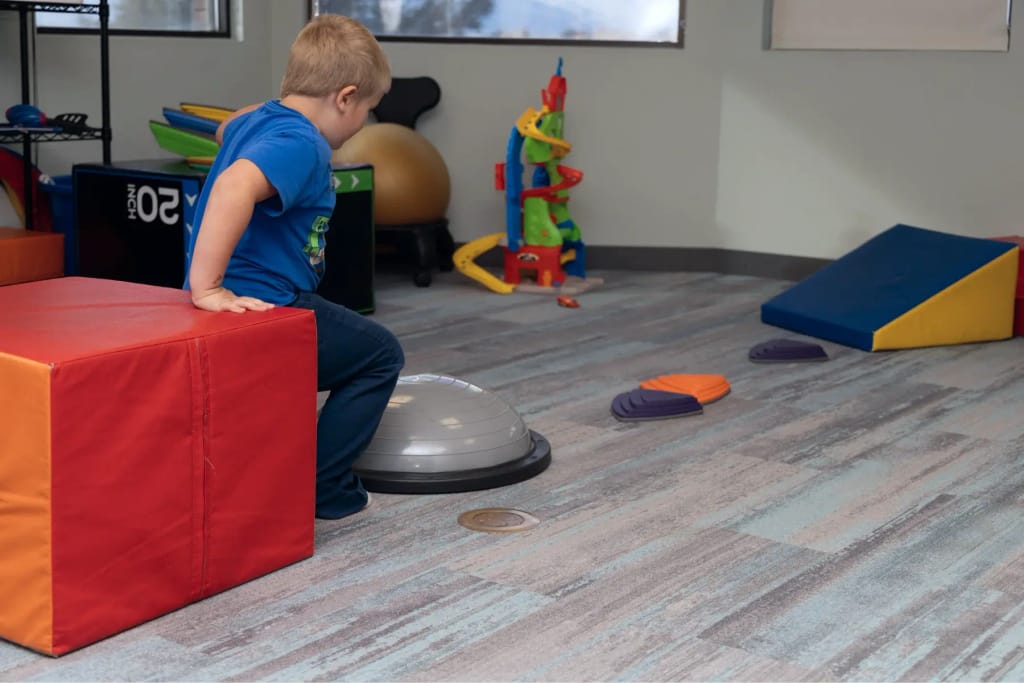 Child using balance equipment at Woven Care Central West