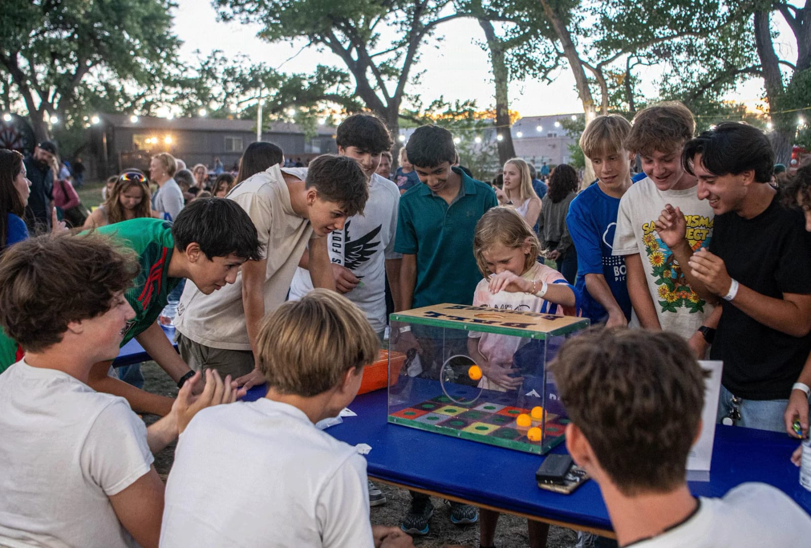 Bosque School students gathered around project displays outdoors on campus.
