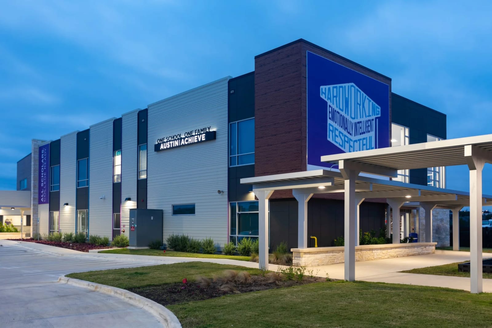 Exterior of the Austin Achieve school building with covered entrance and landscaped grounds in Austin, Texas.