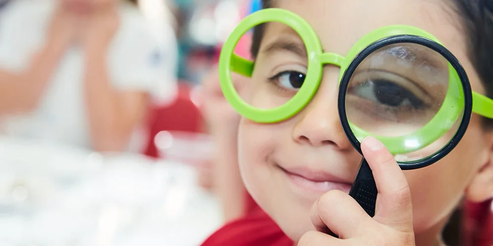 A child learning through discovery at Spanish Schoolhouse Fort Worth