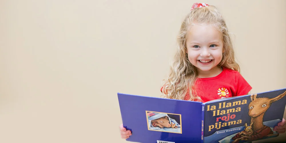 A young student enjoying a book at Spanish Schoolhouse Fort Worth