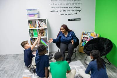 A teacher reads with students in a City Innovation School classroom
