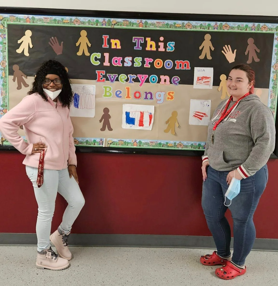 Pontiac Academy for Excellence educators stand beside a classroom belonging display.