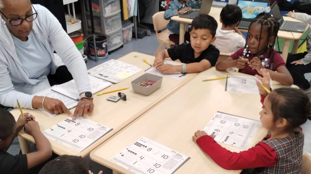 An Invictus Leadership Academy teacher leads students in a classroom lesson