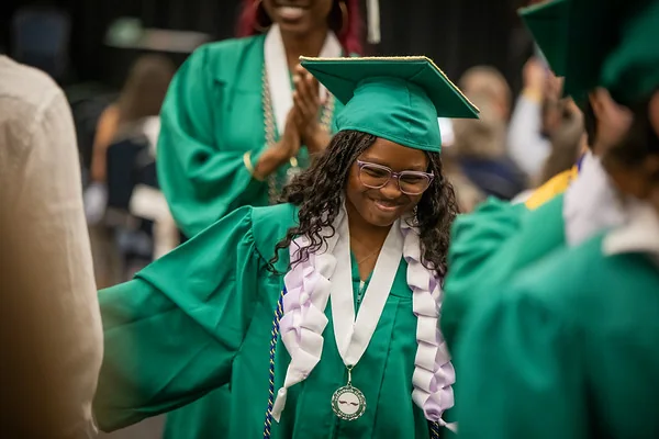 A Greenwood School graduate celebrates at a Jacksonville school ceremony.