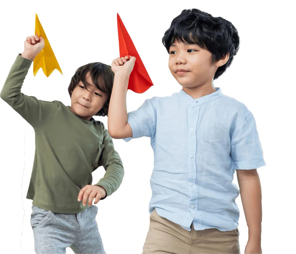 Two children playing with paper airplanes