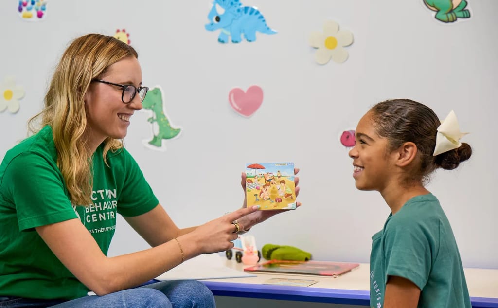 Therapist supporting a young person during an activity