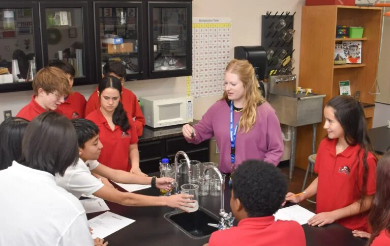Menaul School students gathered around a classroom science demonstration.