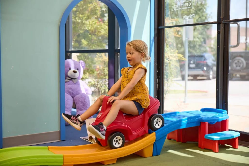 Child playing on indoor activity equipment