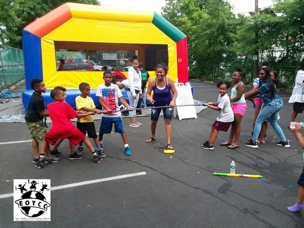 East Orange Youth Cultural students playing a team game outdoors