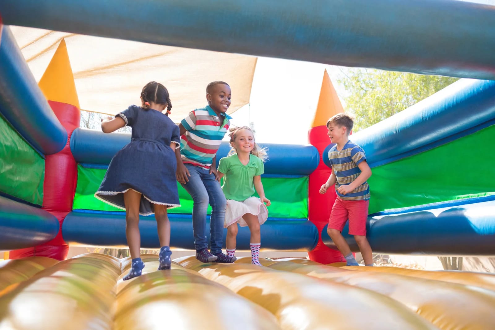 Children playing together on an inflatable activity at the Play Therapy Center of Charleston.