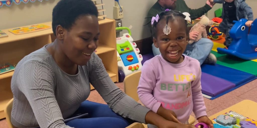 Triumph Inc. early-learning classroom staff and child participate in an activity.