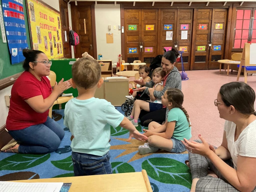 Triumph Inc. early-learning staff and children participate in a classroom activity.