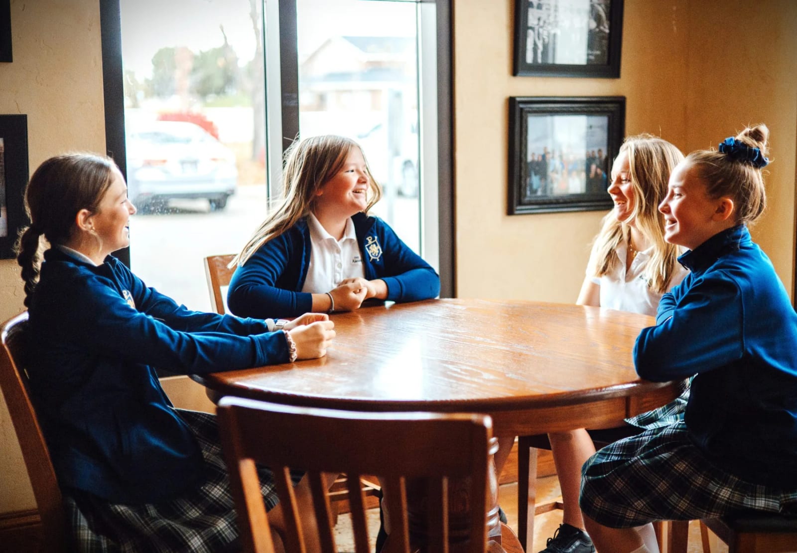 The Ambrose School students meeting together around a classroom table.