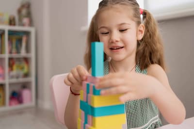 Child playing with colorful wooden blocks