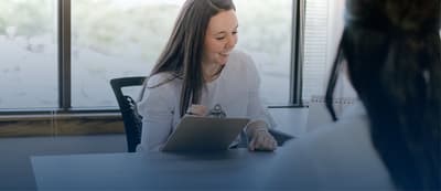 Clinician meeting with a client at a desk