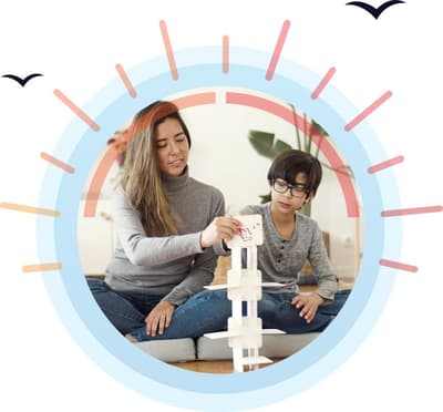 Adult and child build a tower during a learning activity