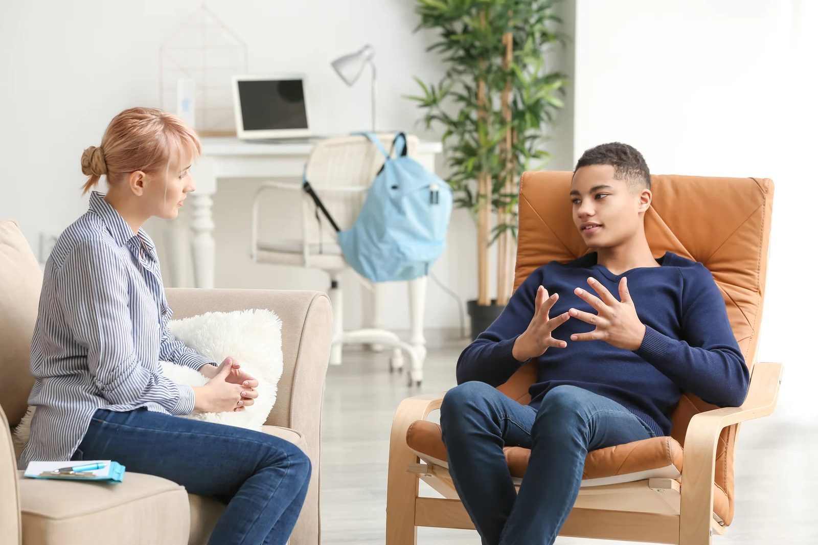Two adults talking in a comfortable room.