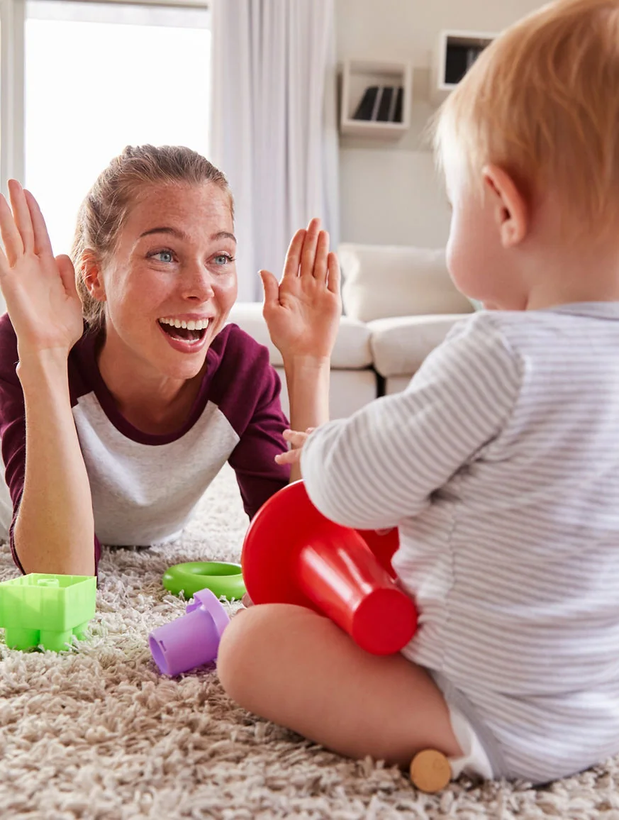 Adult and child sharing a high five during play