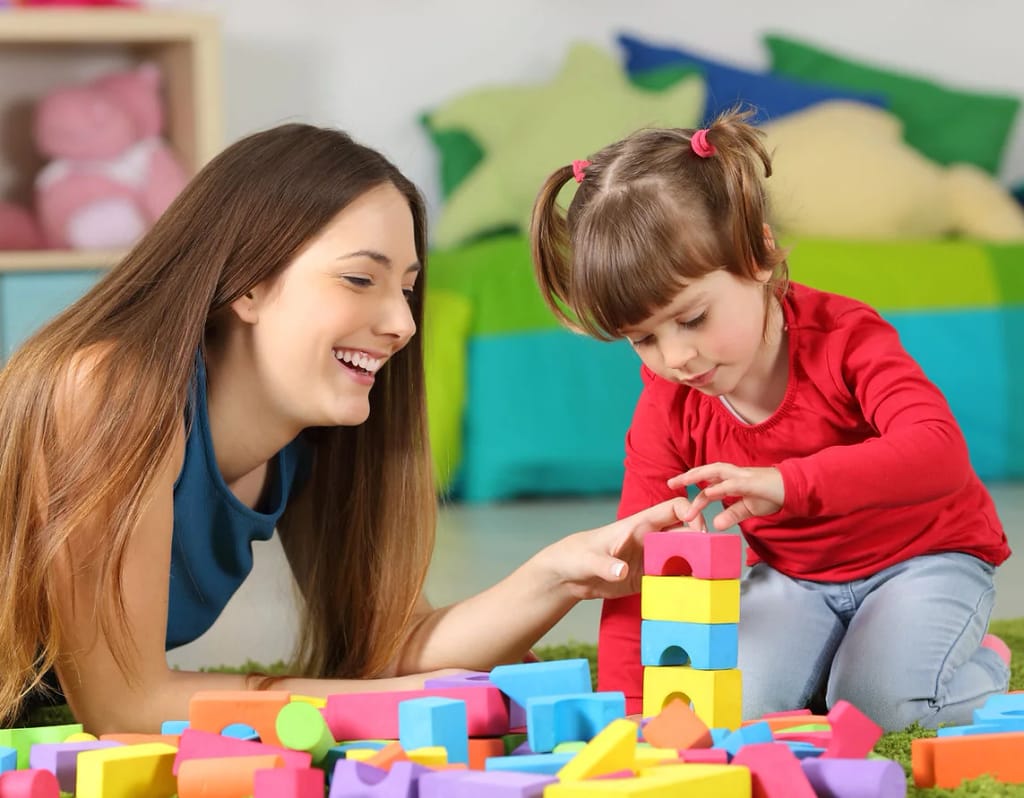 Adult and child working together with building blocks