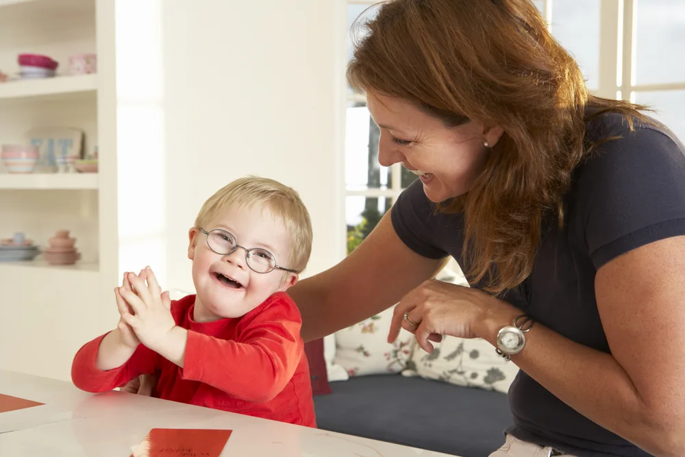 Speech therapist working with a child at a table