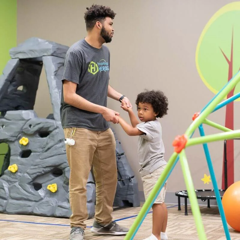 Hopebridge therapist supporting a child during a movement activity