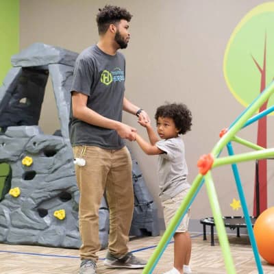 Hopebridge therapist supporting a child during a movement activity